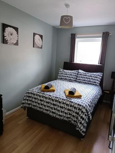 a bedroom with a bed with two hats on it at Location! 2 bed city centre with free parking in Belfast