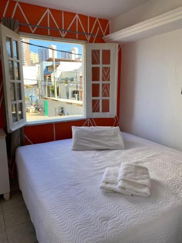 a bedroom with a bed with two towels on it at Pousada Oásis in Fortaleza