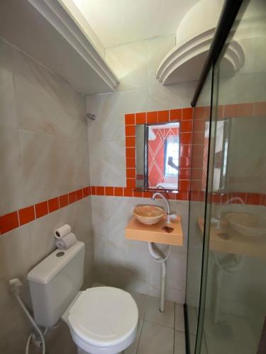 a bathroom with a toilet and a sink at Pousada Oásis in Fortaleza