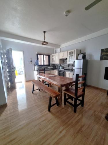 a large kitchen with a wooden table and chairs at Trail Bedz Homestay in Baguio