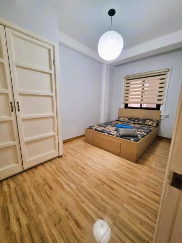 a bedroom with a bed and a open door at Trail Bedz Homestay in Baguio