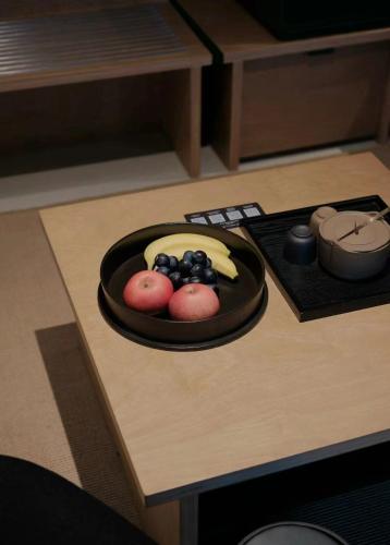 a plate of fruit sitting on a table at Jiangnan House Nantou in Shenzhen