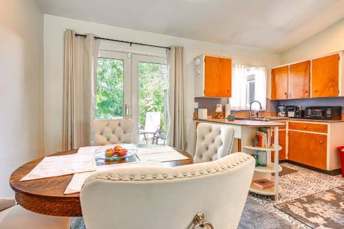 a kitchen and dining room with a table and chairs at 3 Mi to Michigan State Duplex with Patio in Lansing in Lansing