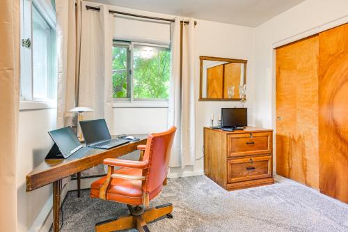an office with a desk with a laptop and a chair at 3 Mi to Michigan State Duplex with Patio in Lansing in Lansing
