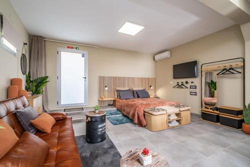 a bedroom with a bed and a couch at Basalto in Seixal