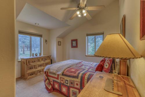 a bedroom with a bed and a table with a lamp at 460 Hills Circle in Nutria