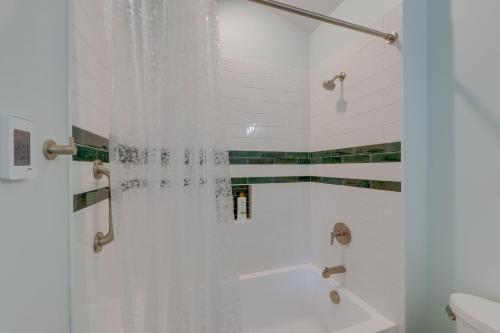 Un baño con ducha con cortina de ducha. en Awesome Missoula Home with Patio Less Than 2 Mi to Downtown!, en Missoula