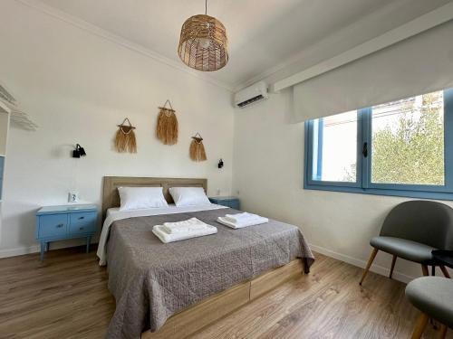 a bedroom with a bed with two towels on it at Assamaris Beachfront House in Asprovalta