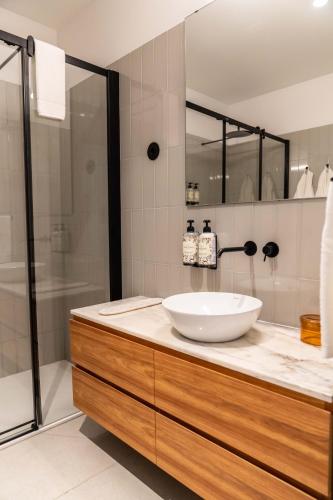 a bathroom with a sink and a shower at The Farm - Azores Boutique House in Ponta Delgada
