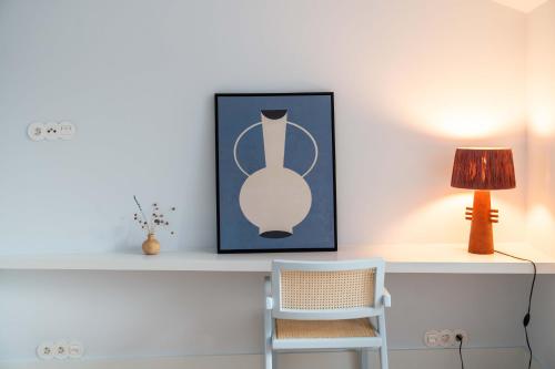 a white desk with a lamp and a chair at The Farm - Azores Boutique House in Ponta Delgada