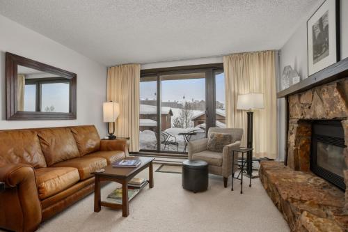 a living room with a couch and a fireplace at Pool, Hot Tub, Sauna, Amazing Ski Area Views, Partially Covered Patio in Steamboat Springs