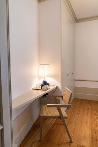 a desk with a lamp and a chair in a room at The Farm - Azores Boutique House in Ponta Delgada