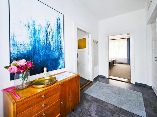 a bathroom with a sink and a painting on the wall at Václavkova Apartment in Mladá Boleslav