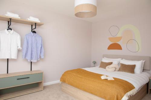 a bedroom with a bed and a dresser and clothes racks at Bob W London St Paul's in London