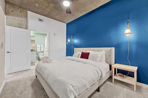 a blue bedroom with a bed and a blue wall at 1700 Bassett, Unit 818 in Denver