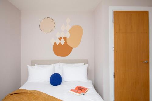 a bedroom with a white bed with a blue ball on it at Bob W London St Paul's in London