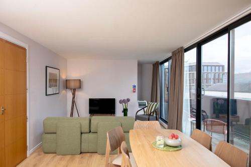 a living room with a couch and a table at Bob W London St Paul's in London