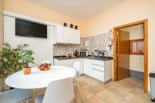 a kitchen with a white table and a white counter top at Cobalt in Seixal