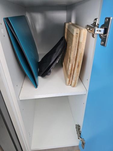 a shelf with notebooks and books in a drawer at SantoriniRD in Punta Cana