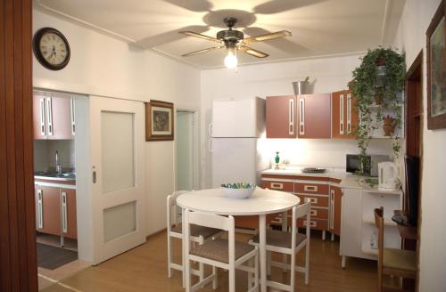 a kitchen with a table and a clock on the ceiling at Dimora dei Seclì in Galatina