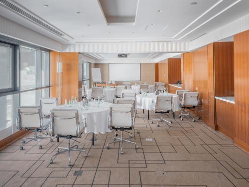 a conference room with a table and chairs in a room at The Hotel Galleria Jeddah, Curio Collection by Hilton in Jeddah