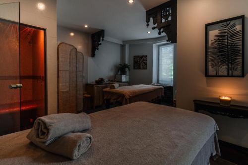 a room with two beds and a sink in it at Villa Kerasy Hotel Spa in Vannes