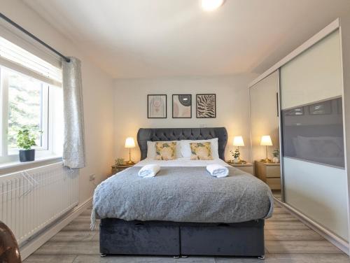 a bedroom with a large bed and a window at Manchester Double Room Near Parks Free Parking in Broadheath
