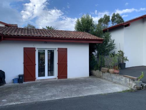 a small white garage with a door at Kayola 2 in Saint-Jean-de-Luz