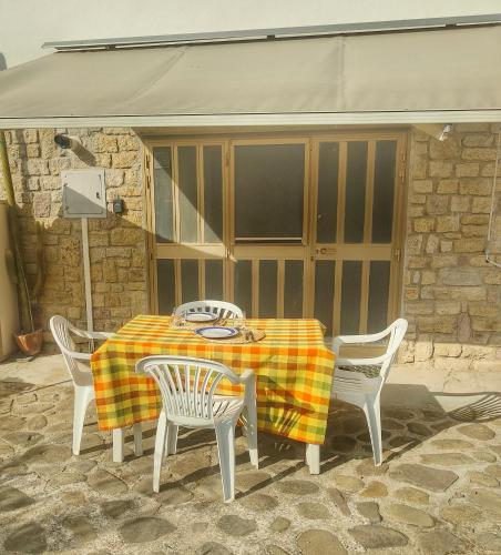 a table and chairs with a table and a tent at La Gaura Relax e Mare in Castiglione della Pescaia