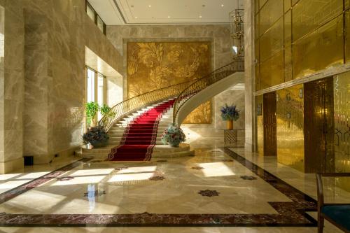 a staircase in a building with a red carpet at The Hotel Galleria Jeddah, Curio Collection by Hilton in Jeddah