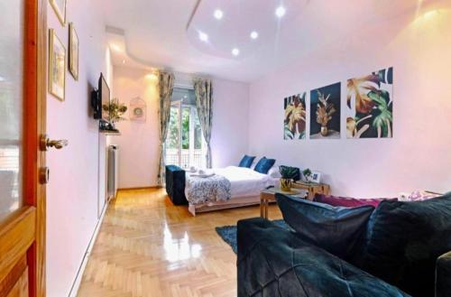 a living room with a couch and a bed at Cozy apartment near Saint Sava Temple in Belgrade