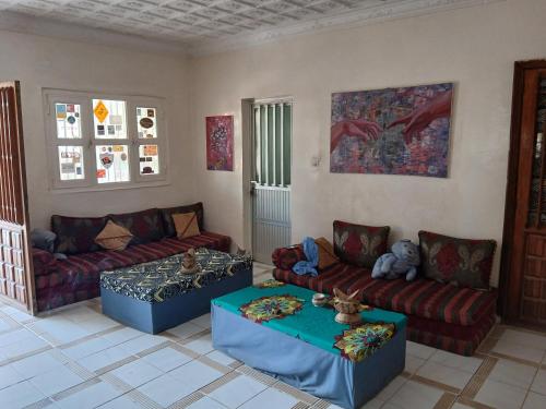 a living room with two couches and a table at Auberge Triskell in Nouakchott