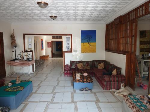 a living room with couches and a tile floor at Auberge Triskell in Nouakchott
