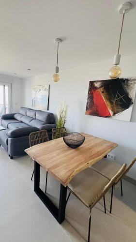 a living room with a table and a couch at Complejo Bellavista Residencial in Pego
