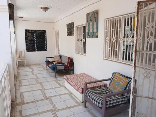 a living room with two chairs and a couch at Auberge Triskell in Nouakchott