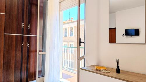 a kitchen with a sliding glass door to a balcony at MaisonV-Vivi il centro e il mare in Porto San Giorgio
