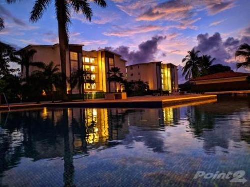 a large swimming pool in front of a building at The Wavefront Beachfront Condo In Bejuco in Bejuco