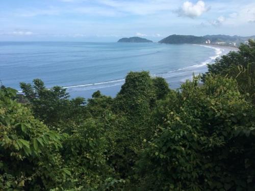a view of a beach with trees and the ocean at The Wavefront Beachfront Condo In Bejuco in Bejuco
