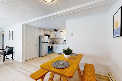 a living room with a table and a kitchen at Rehoboth Beach --- Harper's Nest - 103 Truitt Ave in The Plantations