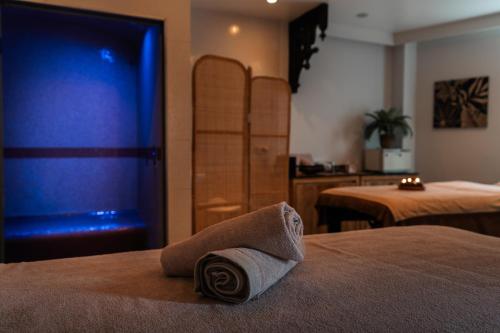 a hotel room with a rolled up towel on a bed at Villa Kerasy Hotel Spa in Vannes