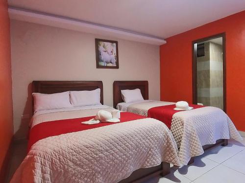 Postel nebo postele na pokoji v ubytování Hostal Flor de los Angeles Salcedo