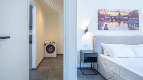 a bedroom with a bed and a washing machine at EasyTopStay - Gelsomino Charming Flat in Rome