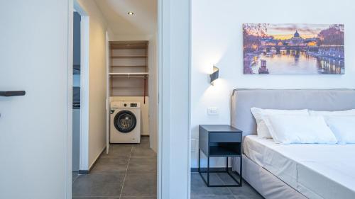 a bedroom with a bed and a washing machine at EasyTopStay - Gelsomino Charming Flat in Rome