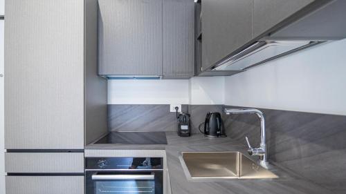 a small kitchen with a sink and a stove at EasyTopStay - Gelsomino Charming Flat in Rome