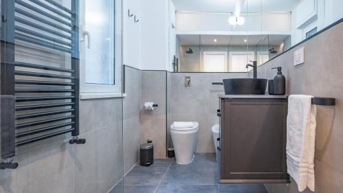 a bathroom with a sink and a toilet in it at EasyTopStay - Gelsomino Charming Flat in Rome