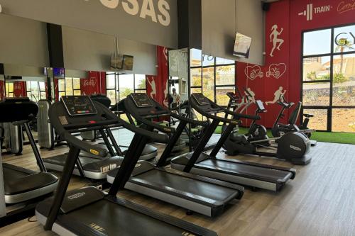 a gym with treadmills and elliptical machines at Bahia Principe Sunlight Costa Adeje - All Inclusive in Adeje
