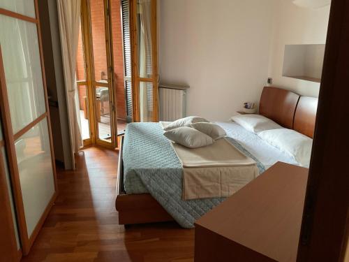 a bedroom with a bed with two pillows on it at Appartamento al lago in Corgeno