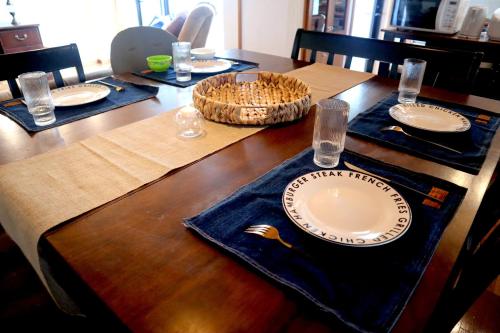 a wooden table with a plate on top of it at 【NewOpen】人気の観光地北谷に立地! 最大14名様 in Hamakawa