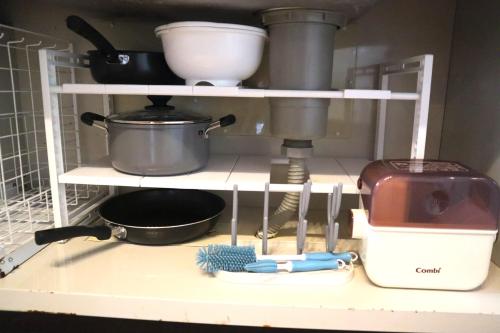 a kitchen shelf with cooking utensils and a mixer at 【NewOpen】人気の観光地北谷に立地! 最大14名様 in Hamakawa