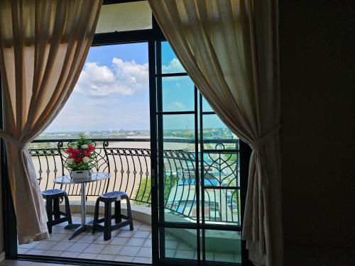 a view of a balcony with a table and chairs at Kenyalang Riverine Emerald Condominium Homestay in Kuching